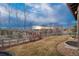 Large backyard with grassy lawn, mature trees, and wooden fence, offering privacy at 237 Maplehurst Dr, Highlands Ranch, CO 80126