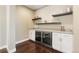 Home bar area with wine fridge and shelving at 237 Maplehurst Dr, Highlands Ranch, CO 80126