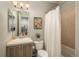 Cozy bathroom featuring a shower-tub combination, a white shower curtain, and a single sink at 237 Maplehurst Dr, Highlands Ranch, CO 80126