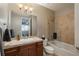 Bathroom featuring a tiled shower-over-tub combination and wood vanity with ample counter space at 237 Maplehurst Dr, Highlands Ranch, CO 80126