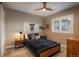 Comfortable bedroom featuring a modern ceiling fan, a window with views, and side tables with lamps at 237 Maplehurst Dr, Highlands Ranch, CO 80126