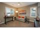 Comfortable bedroom setup with loveseat, desk, and natural light from two windows at 237 Maplehurst Dr, Highlands Ranch, CO 80126