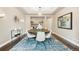 Elegant dining room with an area rug, modern light fixture, and seating for eight at 237 Maplehurst Dr, Highlands Ranch, CO 80126