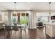 Dining room with modern light fixture, hardwood floors, and sliding door access to the outdoor patio at 237 Maplehurst Dr, Highlands Ranch, CO 80126