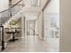 Open foyer with staircase, decorative table and decor, and doorway to office space at 237 Maplehurst Dr, Highlands Ranch, CO 80126