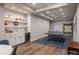 Basement game area with wet bar, shelving, and table tennis on a patterned rug at 237 Maplehurst Dr, Highlands Ranch, CO 80126