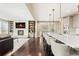 Open-concept kitchen featuring the island with seating and living room with fireplace at 237 Maplehurst Dr, Highlands Ranch, CO 80126