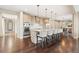 Open kitchen with large island featuring seating and pendant lighting at 237 Maplehurst Dr, Highlands Ranch, CO 80126