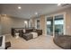 Spacious living area with comfortable seating, neutral decor, and natural light from sliding glass doors at 237 Maplehurst Dr, Highlands Ranch, CO 80126