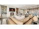 Open-concept living room featuring a fireplace, built-in shelves, and seamless flow to the kitchen at 237 Maplehurst Dr, Highlands Ranch, CO 80126