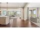 Open-concept living area showcasing the transition from kitchen to living and sitting room at 237 Maplehurst Dr, Highlands Ranch, CO 80126