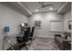 Modern office with sleek desk, dual monitors, gaming chairs, and comfortable lounge area at 237 Maplehurst Dr, Highlands Ranch, CO 80126