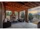 Inviting outdoor patio with a stone fireplace, comfortable seating, and string lights at 237 Maplehurst Dr, Highlands Ranch, CO 80126
