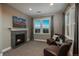 Cozy sitting room with a stone fireplace, large windows with scenic views, and comfortable seating at 237 Maplehurst Dr, Highlands Ranch, CO 80126