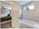 Bathroom view into the bedroom highlighting the tub and window at 4455 Tejon St, Denver, CO 80211