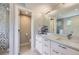 Bright bathroom featuring a double sink vanity, a shower, and a toilet with white tile flooring at 4455 Tejon St, Denver, CO 80211