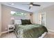 Comfortable bedroom featuring an olive comforter, ceiling fan, and sun-filled window views at 4455 Tejon St, Denver, CO 80211