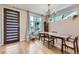 Elegant dining room with a chandelier, large windows, and a modern door at 4455 Tejon St, Denver, CO 80211