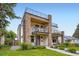 Modern townhouse showcasing a stone facade, balconies, and a rooftop deck at 4455 Tejon St, Denver, CO 80211