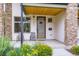 Charming front porch featuring a modern door, stone accents, and decorative plants at 4455 Tejon St, Denver, CO 80211
