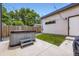 Backyard patio featuring a modern hot tub, landscaping, and fence at 4455 Tejon St, Denver, CO 80211