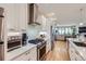 Modern kitchen with white cabinets, stainless steel appliances, and open layout at 4455 Tejon St, Denver, CO 80211