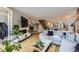 Open-concept living room with hardwood floors, a fireplace, and staircase at 4455 Tejon St, Denver, CO 80211