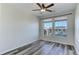 Bright bedroom features a ceiling fan, natural light, and stylish flooring at 13456 Via Varra # 406, Broomfield, CO 80020