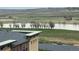 Scenic lake view from the building with a roof in the foreground, combining nature with modern living at 13456 Via Varra # 406, Broomfield, CO 80020