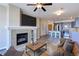 Cozy living room showcasing a fireplace and seamlessly connected modern kitchen at 13456 Via Varra # 406, Broomfield, CO 80020