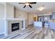 Open living area with fireplace, ceiling fan, and modern kitchen with stainless steel appliances at 13456 Via Varra # 406, Broomfield, CO 80020