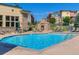 Beautiful swimming pool area with seating and stone fireplace, perfect for relaxing and socializing at 13456 Via Varra # 406, Broomfield, CO 80020