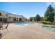 Open community pool and jacuzzi area with seating and stone fireplace, perfect for enjoying summer days at 13456 Via Varra # 406, Broomfield, CO 80020