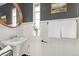 Bathroom with pedestal sink, wood mirror, and white tile at 1410 Vine St # 3, Denver, CO 80206