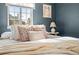 Cozy bedroom featuring warm natural light, stylish pillows, and tasteful decor for a relaxing ambiance at 1410 Vine St # 3, Denver, CO 80206