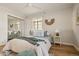 Bright bedroom featuring hardwood floors, two windows, and mirrored closet doors at 1410 Vine St # 3, Denver, CO 80206