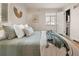 Cozy bedroom featuring hardwood floors, a comfy bed, and calming decor leading to a bathroom at 1410 Vine St # 3, Denver, CO 80206