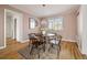 Cozy dining room with hardwood floors, a round table, and a window providing natural light, perfect for intimate meals at 1410 Vine St # 3, Denver, CO 80206
