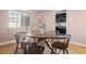Dining room area showcases a round wooden table, four chairs, and a decorative pendant light fixture at 1410 Vine St # 3, Denver, CO 80206