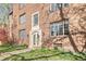 Charming brick apartment building entrance with detailed stonework and flourishing greenery, adding elegance and warmth at 1410 Vine St # 3, Denver, CO 80206