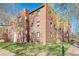 Beautiful three-story brick apartment building featuring lovely landscaping and mature trees at 1410 Vine St # 3, Denver, CO 80206
