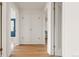 Spacious hallway with hardwood floors and classic white doors leading to various rooms at 1410 Vine St # 3, Denver, CO 80206