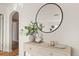 Chic hallway featuring a round mirror, stylish decor, and a glimpse into the adjacent rooms at 1410 Vine St # 3, Denver, CO 80206