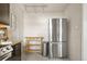 Bright kitchen featuring stainless steel refrigerator and a wooden table and shelving for storage at 1410 Vine St # 3, Denver, CO 80206