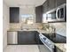 Spacious kitchen showcasing stainless steel appliances, granite counters, and dark wood cabinets at 1410 Vine St # 3, Denver, CO 80206
