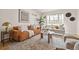 Cozy living room with stylish sofas, a round marble coffee table, a large window, and an elegant area rug at 1410 Vine St # 3, Denver, CO 80206