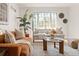 Sunlit living room with modern furnishings, a large window, and neutral tones creating a relaxing space at 1410 Vine St # 3, Denver, CO 80206