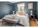 Elegant main bedroom featuring a comfortable bed with decorative pillows, dark walls, and ambient lighting at 1410 Vine St # 3, Denver, CO 80206