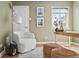 Office with a cozy white chair, wooden desk, and natural light, enhanced by neutral colors and tasteful decor at 1410 Vine St # 3, Denver, CO 80206