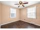 Empty bedroom with natural light, ceiling fan, wood floor and neutral paint at 2718 S Hazel Ct, Denver, CO 80236